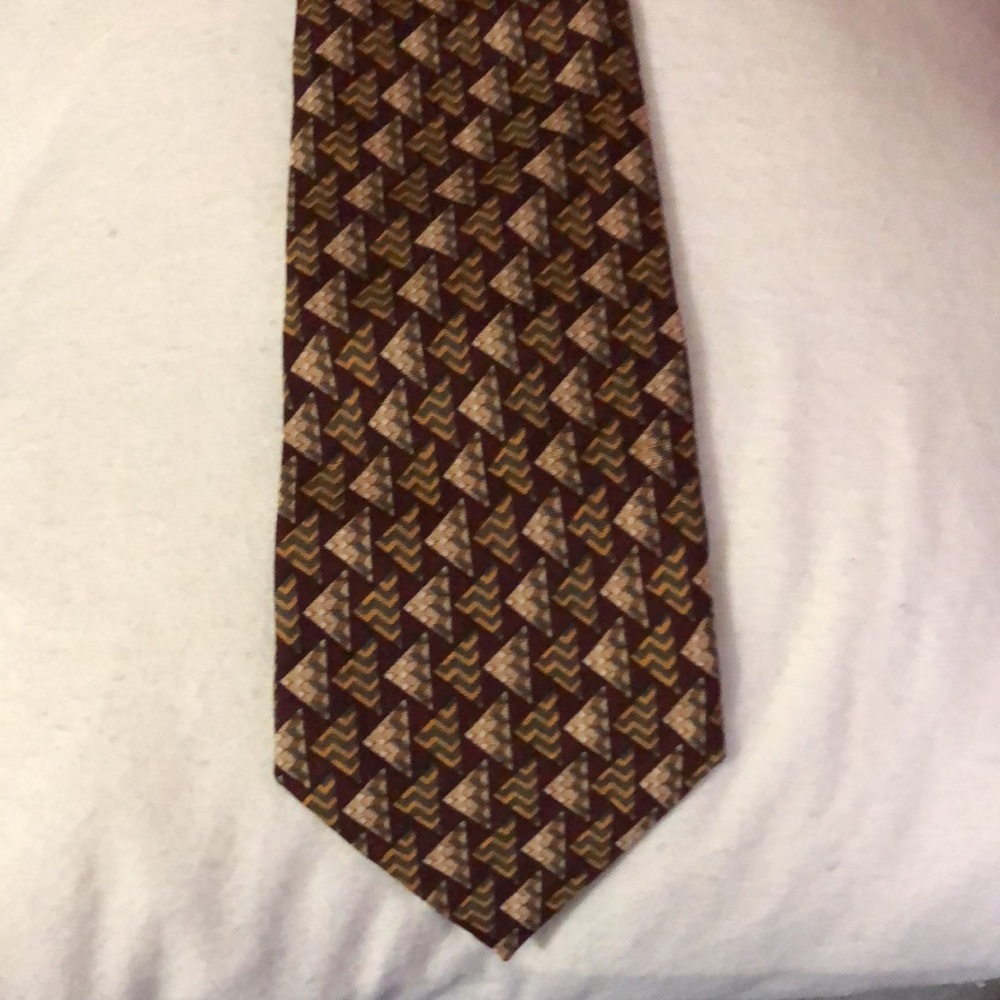 Brand unknown. Tie in great shape no tears or stains . 100%silk made in Korea.